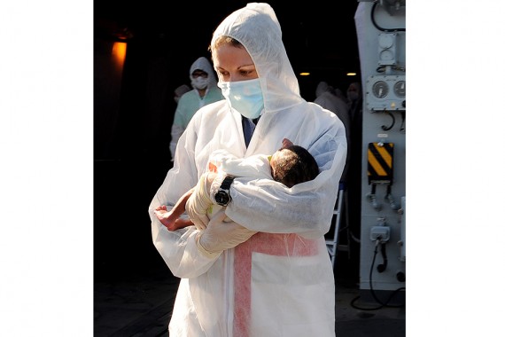 HMS RICHMOND Rescue 101 Migrants HMS RICHMOND as part of the European Maritime Forces Rescue 101 Migrants off the North Coast of Africa. Image of Medical Assistant Stacey Oakendon from HMS RICHMOND holding a 9 day old baby.